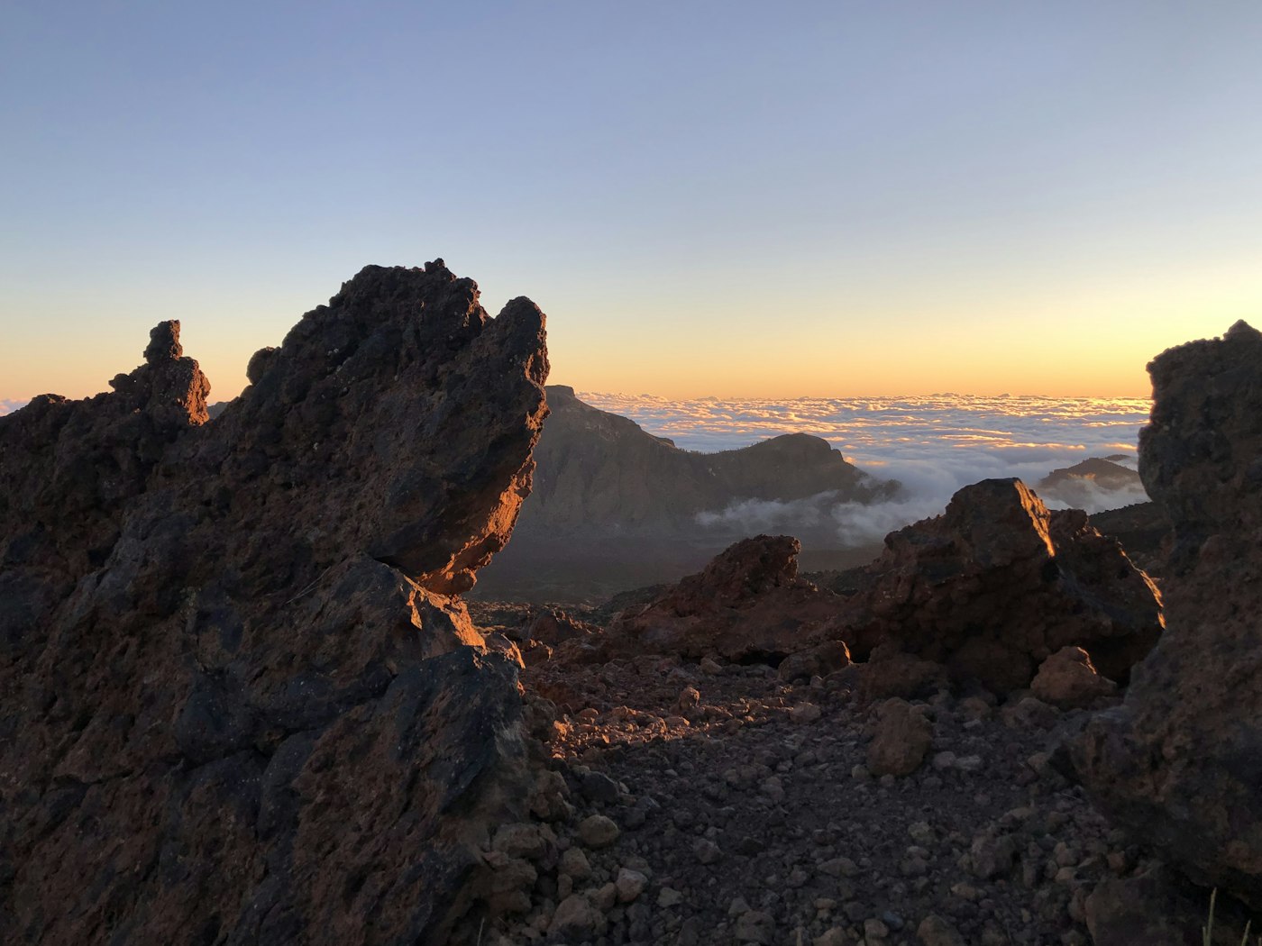 Hikers traversing volcanic terrain in the Canary Islands