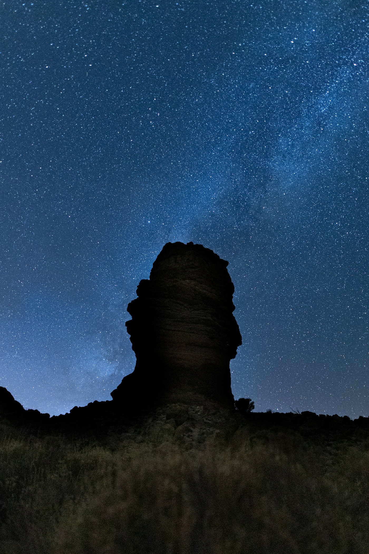 The Milky Way stretching over mountain silhouettes in the Canary Islands